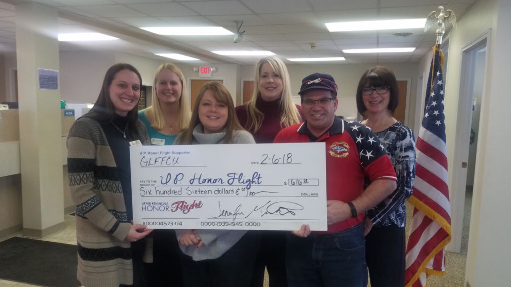 Gladstone staff presents a donation to the U.P. Honor Flight from Dress Down donations and member donations from Veteran's Day